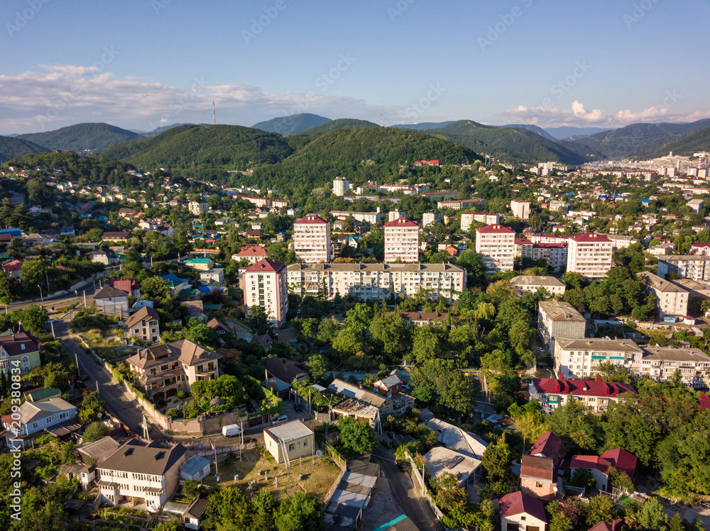 Aerial drone view on Tuapse town and hills on horizone at day time in summer Aerial drone view on Tuapse town and hills on horizone at day time in summer