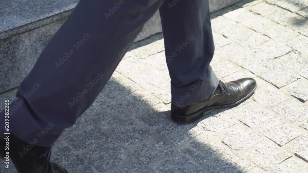 a man in a suit suit goes to a meeting on the background of a business center. Increased gait. Shooting legs in shoes 4K a man in a suit suit goes to a meeting on the background of a business center. Increased gait. Shooting legs in shoes 4K