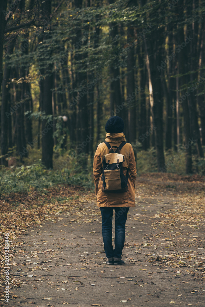 Young stylish hipster girl standing in the autumn park and smiling, retro vintage image Young stylish hipster girl standing in the autumn park and smiling, retro vintage image