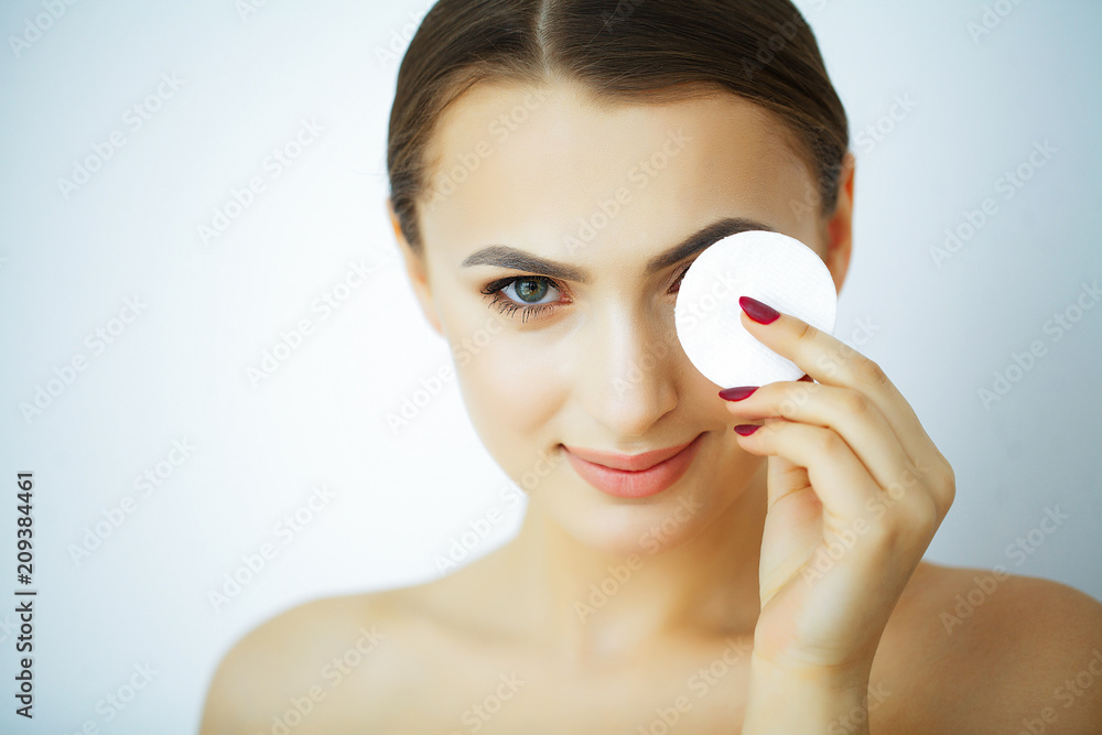 Beauty and Care. Young Beautiful Woman with Pure Skin. Holds in Hand Cotton Pads. Portrait of a Woman with a Smile. High Resolution Beauty and Care. Young Beautiful Woman with Pure Skin. Holds in Hand Cotton Pads. Portrait of a Woman with a Smile. High Resolution
