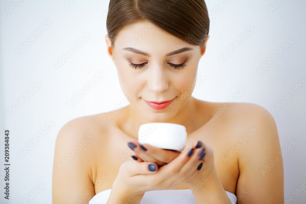 Beauty and Care. Happy Smiling Young Woman Holds Cream for Face. Girl After Shower. Morning Face Care. Pure Skin. High Resolution Beauty and Care. Happy Smiling Young Woman Holds Cream for Face. Girl After Shower. Morning Face Care. Pure Skin. High Resolution