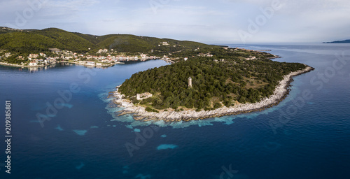 Aerial view of the Fiscardo fishing village and Venetian lighthouse on Kefalonia island