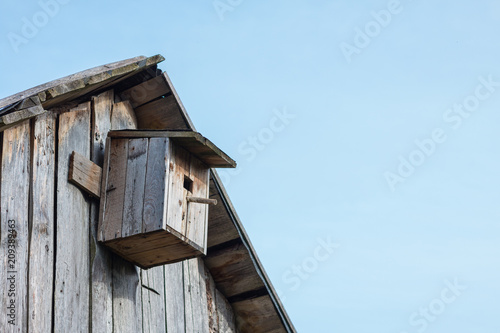 Wooden birdhouse on a wooden barn wall 3