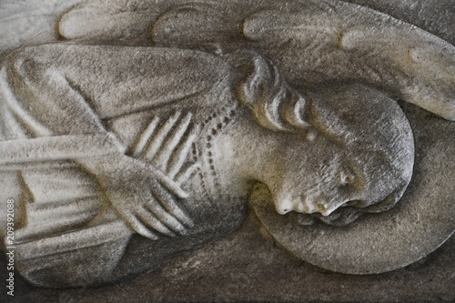 Sculpture of a praying angel on an old tomb of the cemetery of Montreal-Canada