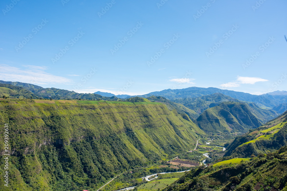 Intag Valley from the ground looking at the river Intag and houses with blue sky in Ecuador near  Otavalo