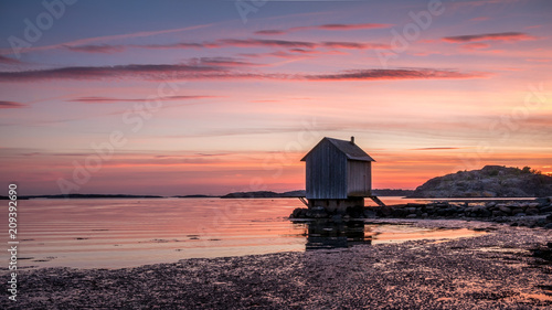 Beautiful sunset over Baltic sea near Gothenburg city, Sweden. Wooden house on seacoast © iuliia_n