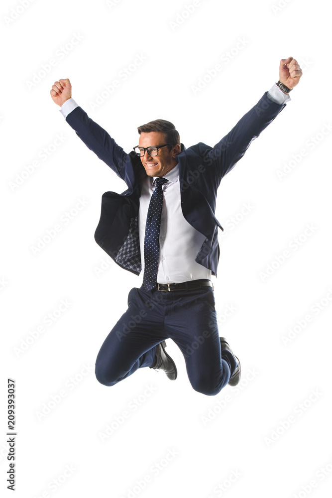 excited businessman in eyeglasses jumping with raised wide arms isolated on white background
