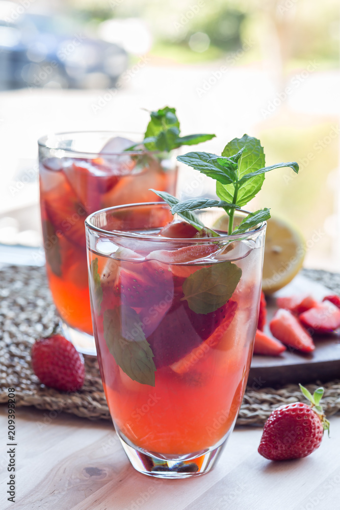 Homemade iced tea with strawberries and mint, vertical Homemade iced tea with strawberries and mint, vertical