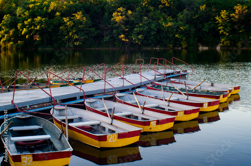 Photography Pleasure rowing boats moored at the pier in the evening pond