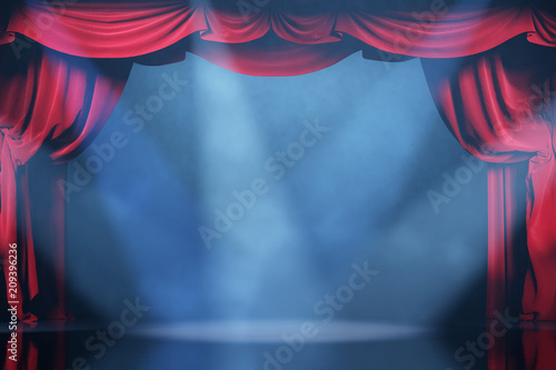 Volume light and smoke on the theater stage with red velvet curtains. 