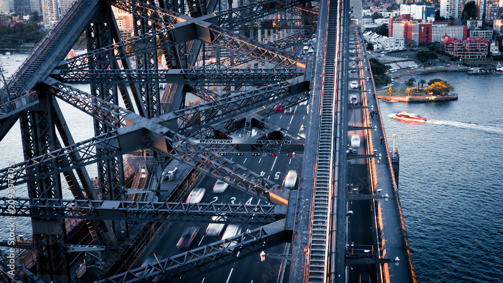 Fototapeta premium Traffic flowing over the Sydney Harbour Bridge at Sunset