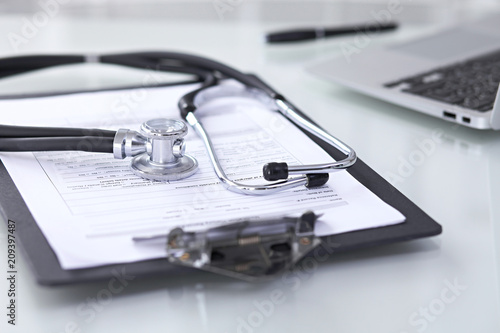 Wallpaper Mural Stethoscope lying at the desk with medical history records and laptop computer. Medicine doctor's working table concept Torontodigital.ca
