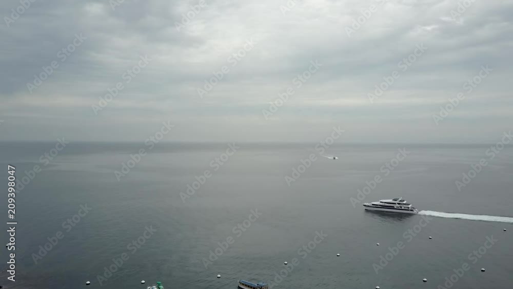 A yacht cruises across the ocean leaving a stunning white trail across the blue waters, aerial footage A yacht cruises across the ocean leaving a stunning white trail across the blue waters, aerial footage