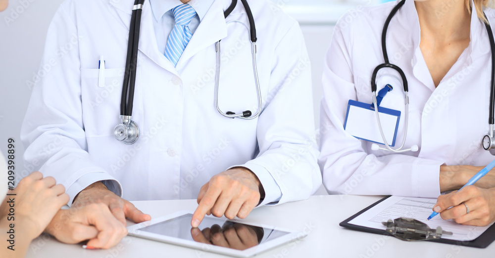 Doctor and patient talking while sitting at the table . Concept of support and trust in medicine Doctor and patient talking while sitting at the table . Concept of support and trust in medicine