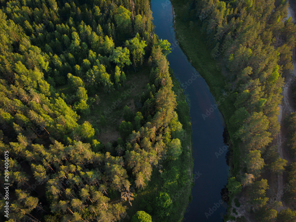 top view to bending river in green forest on sunset top view to bending river in green forest on sunset