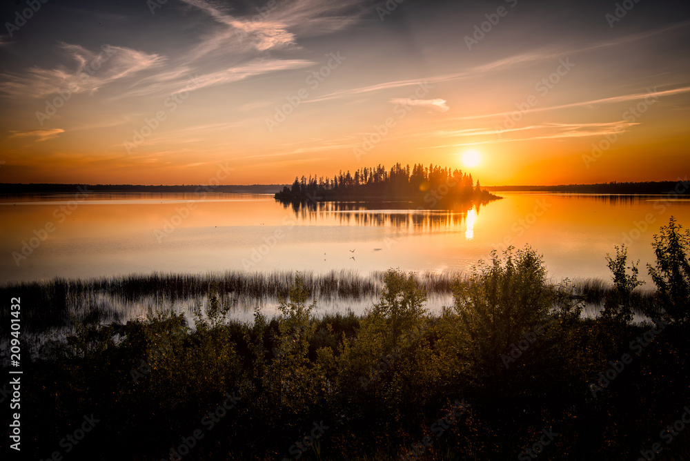 Obraz premium Yellow sunset over river with silhouette