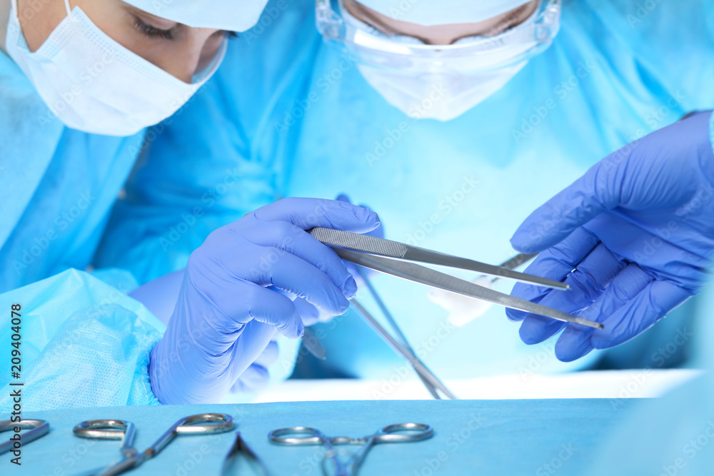 Fototapeta premium Close-up of medical team performing operation. Group of surgeons at work are busy of patient. Medicine, veterinary or healthcare and emergency in hospital