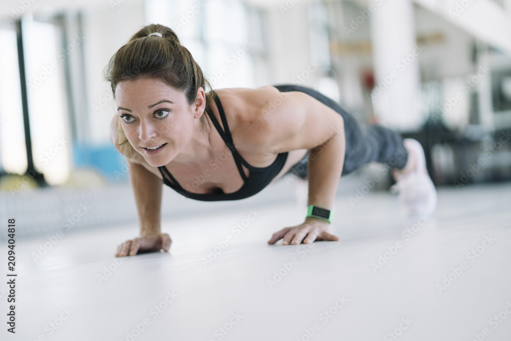 Woman who performs mobility exercises in the gym Woman who performs mobility exercises in the gym