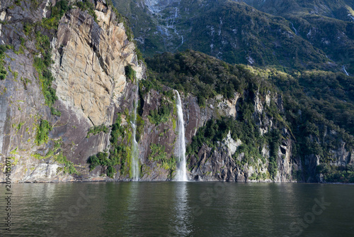 Waterfall near the milford sound in new zealand travel photography 