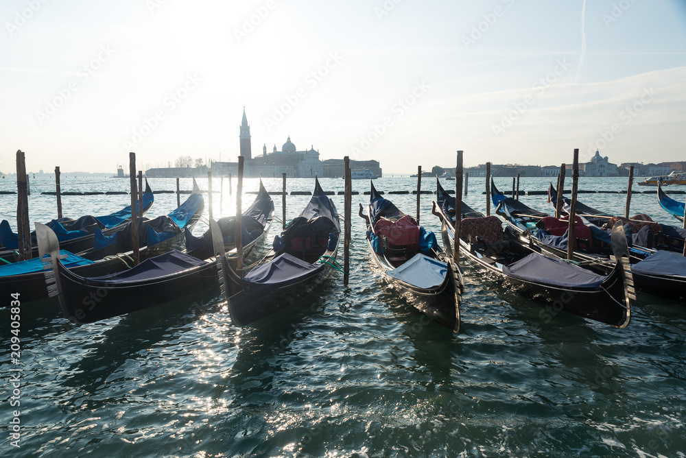 Gondola in Venice Italy during a bright sunny day over the waters in the Mediterranean ocean 