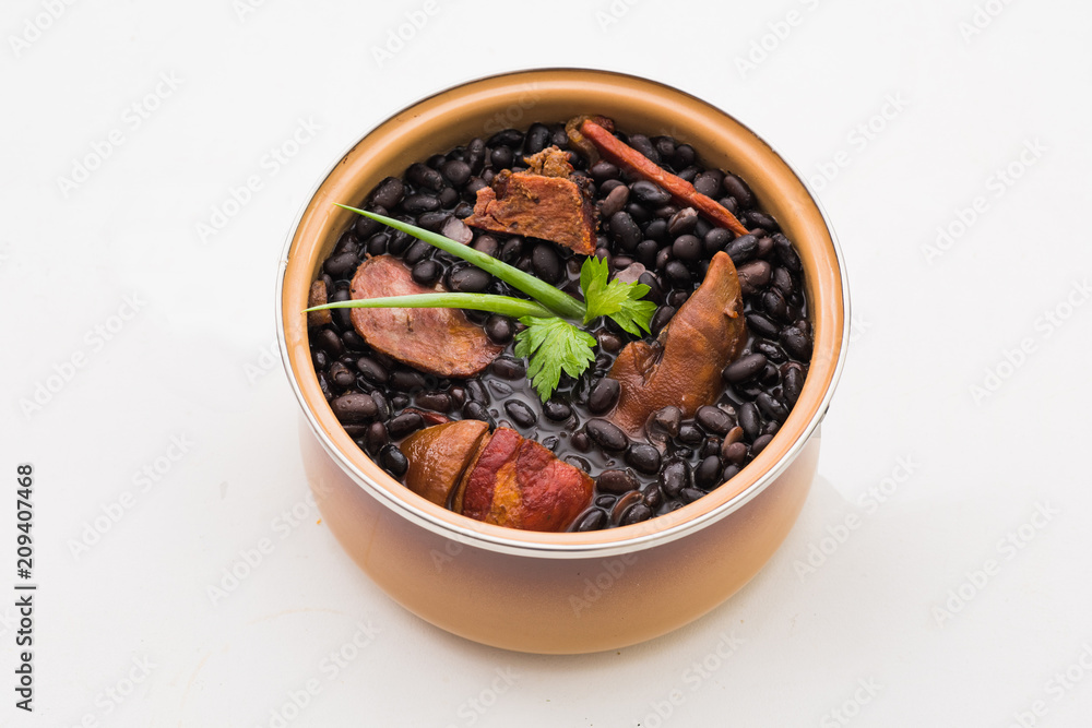 Mini Brazilian feijoada ready for consumption on white background Mini Brazilian feijoada ready for consumption on white background