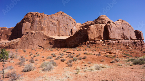 Shadow of  Man with dog on a leash  on a cliff- Arches National Park