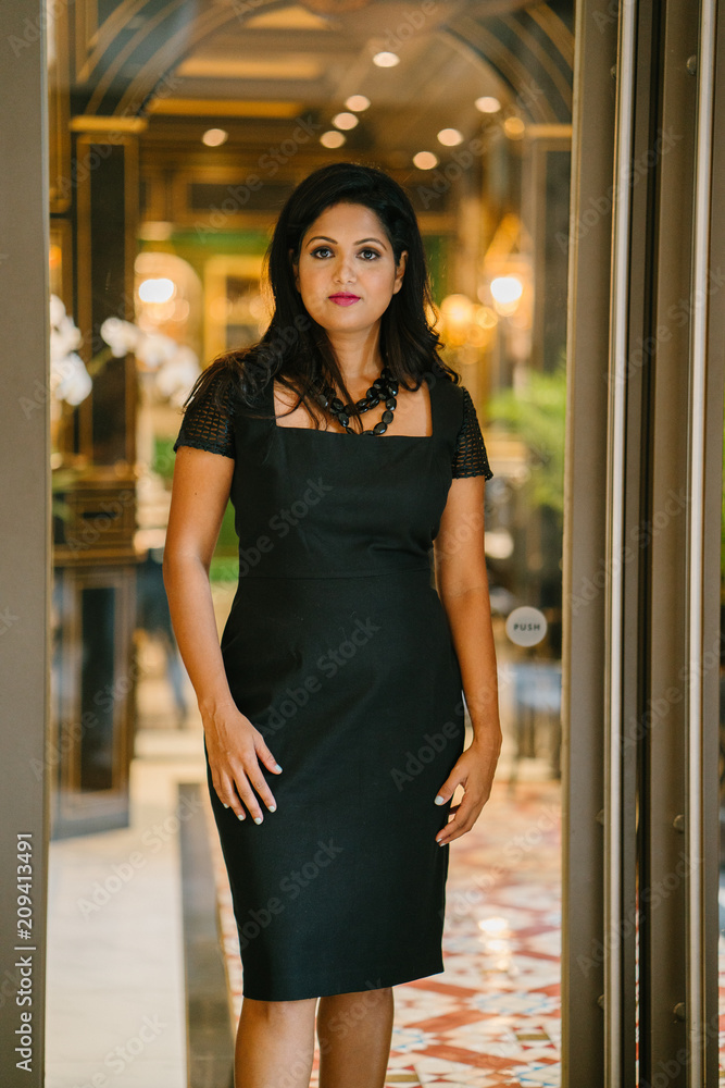 An image of a successful and attractive Indian Asian woman . She is smiling glamorously at the camera and is wearing an elegant black dress. An image of a successful and attractive Indian Asian woman . She is smiling glamorously at the camera and is wearing an elegant black dress.