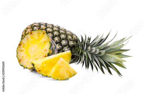 whole with slice ripe pineapple isolated on white background