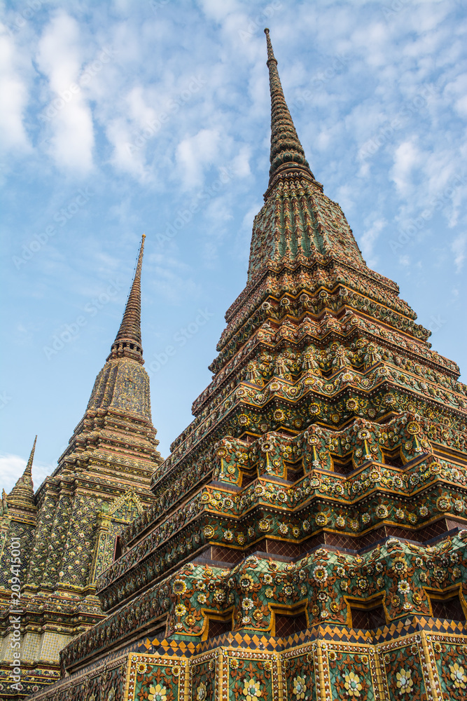 Fototapeta premium Pagoda is in Wat Pho that was named as the temple of the pagoda or chedi that are decorated with yellow glaze or glazed tiles or dark blue. 