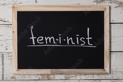 The word "feminist" written on chalkboard. Women's rights movement. Feminism concept © VeronikaSmirnaya