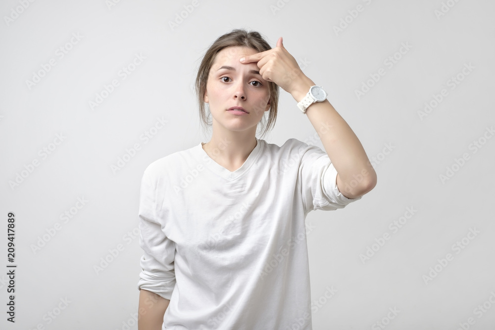 Pretty caucasian woman pulling a smile on her face. Concept of loss of work or being alone Pretty caucasian woman pulling a smile on her face. Concept of loss of work or being alone