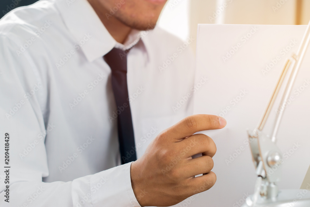 Asian Business man Manager checking and signing applicant filling documents reports papers company application form or registering claim on desk office. Document Report and business busy Concept Asian Business man Manager checking and signing applicant filling documents reports papers company application form or registering claim on desk office. Document Report and business busy Concept