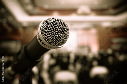 Seminar Conference Concept : Close-up Microphones on abstract blurred of speech in meeting room, front speaking blure people in event convention hall in hotel background