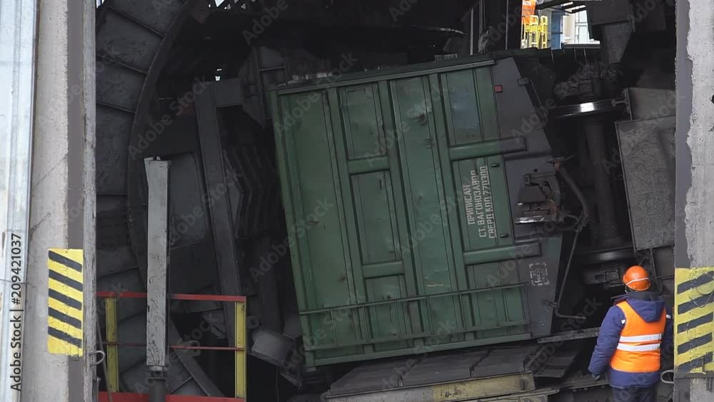Unloading coal from a wagon. The car rolls up wheels Unloading coal from a wagon. The car rolls up wheels