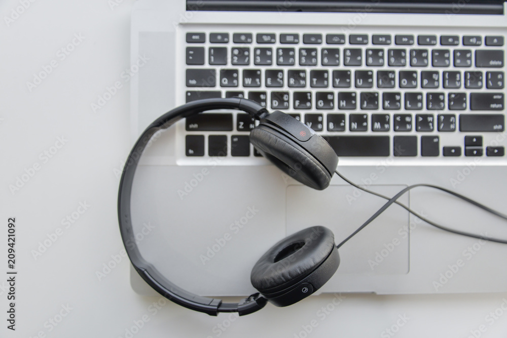 Flay lay of phone headset on the laptop keyboard Flay lay of phone headset on the laptop keyboard