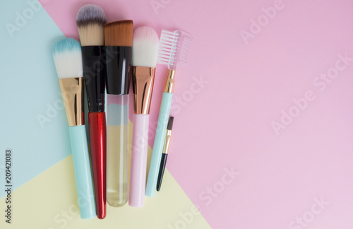 Flat lay creative concept of female decorative for may type of cosmetic cheek brush on the colorful background with copy space