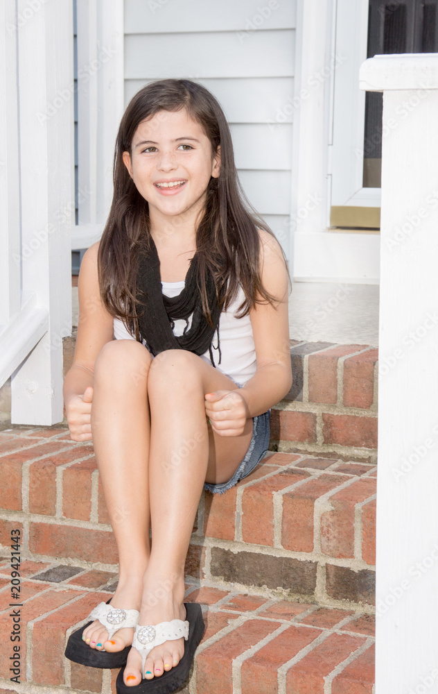 Pretty young girl sitting on steps Pretty young girl sitting on steps