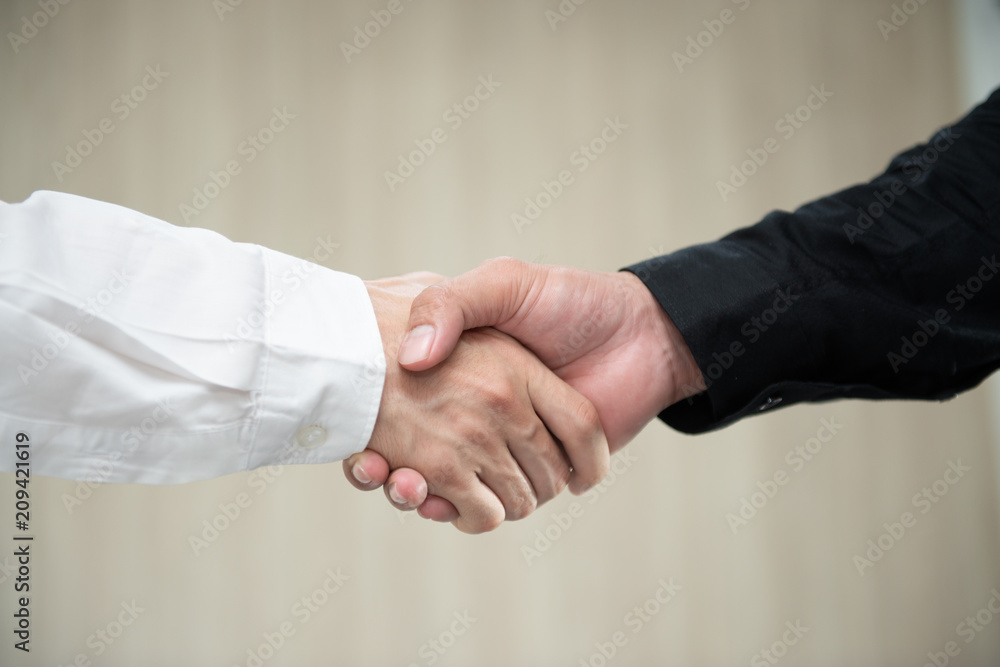 Business man hand shake for business deals Business man hand shake for business deals