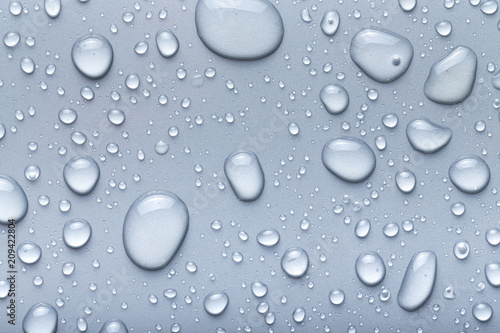 Drops of water on a color background. Gray