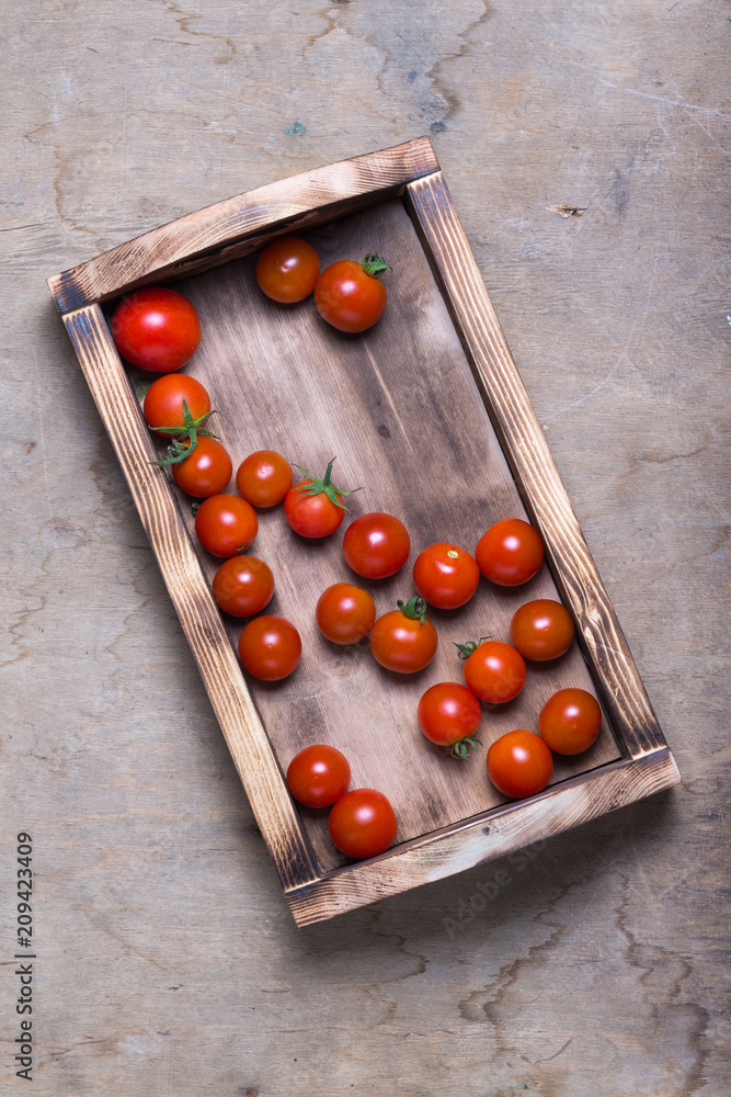 Fresh vegetables and herbs on a wooden burned rustic texture for background. Rough weathered wooden board Fresh vegetables and herbs on a wooden burned rustic texture for background. Rough weathered wooden board