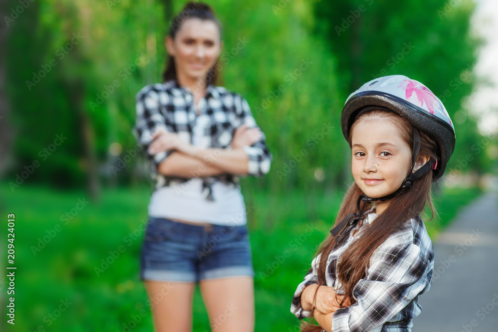 Mother and daughter in a park on summer day Mother and daughter in a park on summer day
