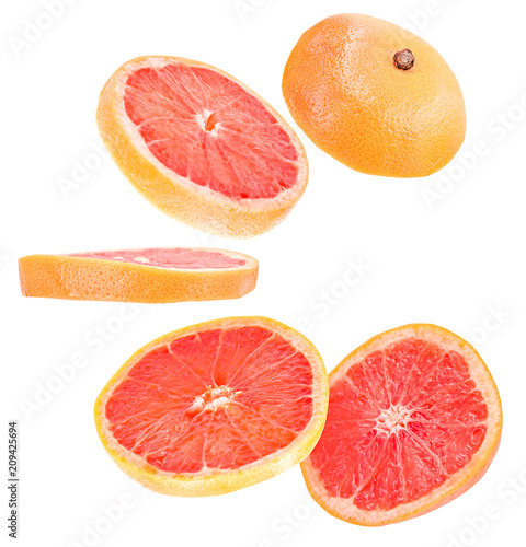 sliced flying grapefruit isolated on white background with clipping path