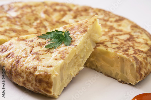 traditional spanish omelette dish with tomato sauce