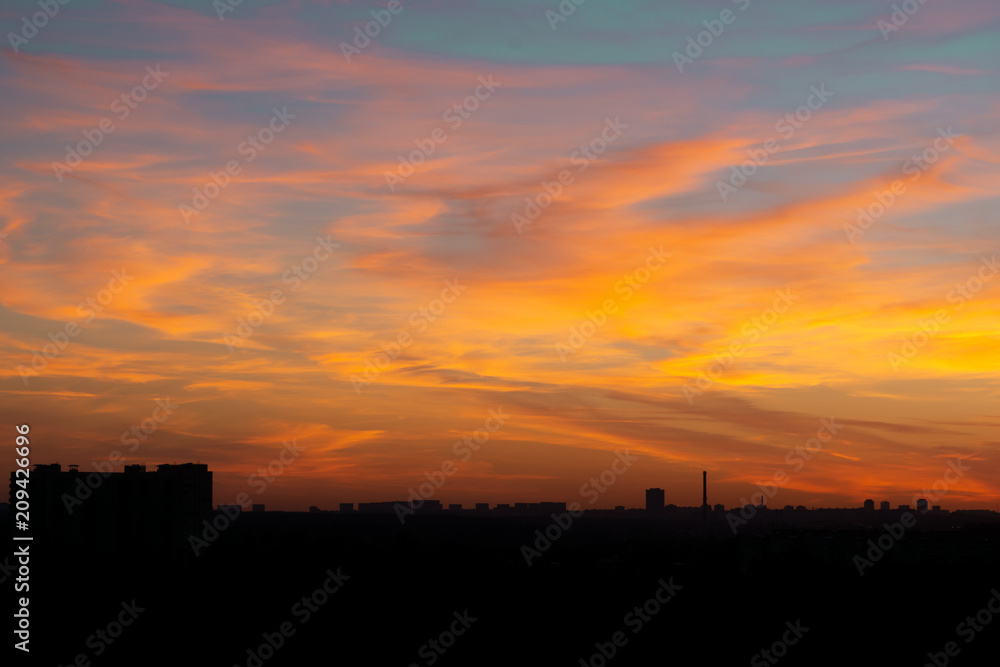silhouetted city on sunset background