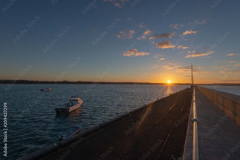 Fototapeta premium Breakwater sunrise calm