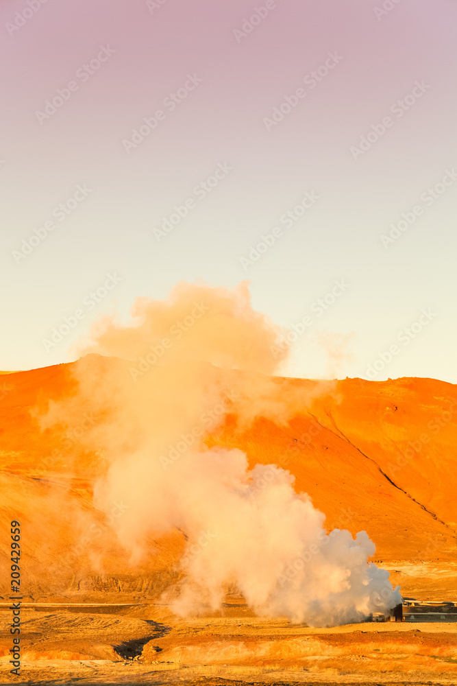 Steam from thermal springs in the desert landscape of Iceland. Toned