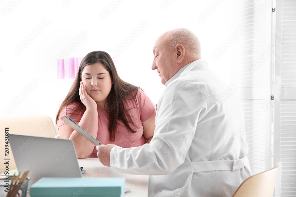 Fototapeta premium Overweight woman having consultation at doctor's office