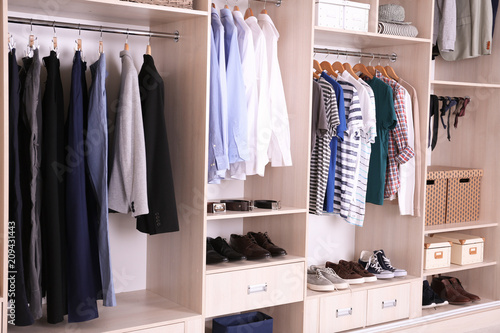 Large wardrobe with different clothes and shoes © New Africa