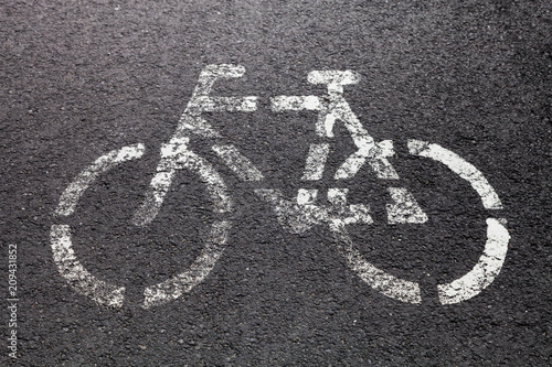 Sign of bike on a gray asphalt
