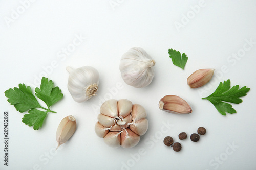 Flat lay composition with garlic on light background